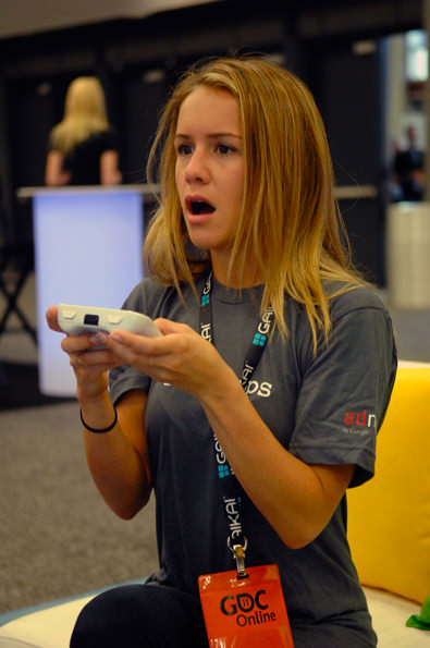 Girl plays HTML5 game at Google booth at GDC Online 2011